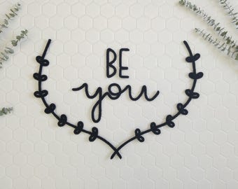 Word, phrase, quote between half Crown of leaves in knitting wool, wall decor, be you