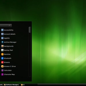 May include: A computer desktop interface with a green background and a black application menu. The menu includes options like "All Applications," "Graphics," and "Wine." Icons are colorful, and the time is displayed in the bottom right corner.