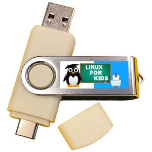 May include: A silver and white USB flash drive with a blue and white label that says "LINUX FOR KIDS". The label features a cartoon penguin wearing a graduation cap and a smaller penguin holding a laptop.