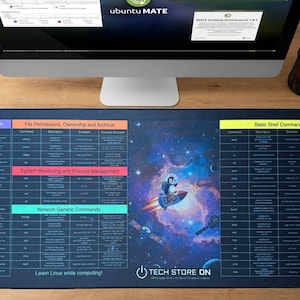 May include: A dark blue rectangular desk mat featuring a space-themed graphic with a penguin on a rocket. The mat displays Linux commands and shortcuts, with the text "Learn Linux while computing!" and "TECH STORE ON".
