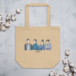 May include: A beige tote bag with a print of five people in traditional clothing. The text "All of Us Are Dead" is printed below the image.