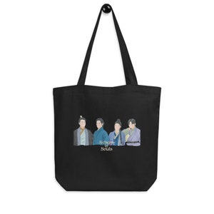 May include: Black tote bag with a white graphic of four men in traditional Korean clothing. The text "Alchemy of Souls" is printed below the image.