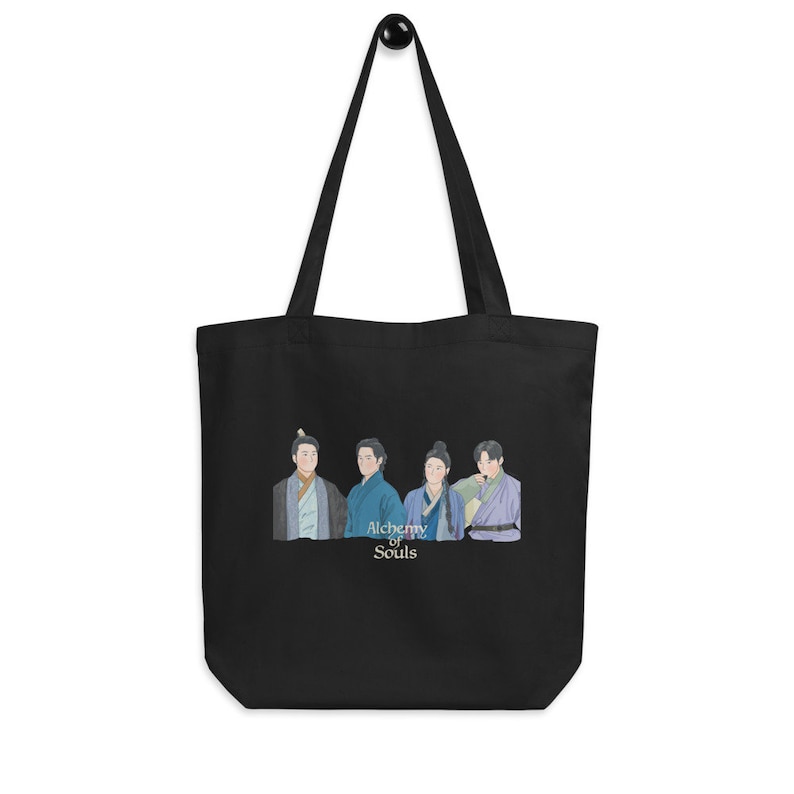 May include: Black tote bag with a white graphic of four men in traditional Korean clothing. The text "Alchemy of Souls" is printed below the image.