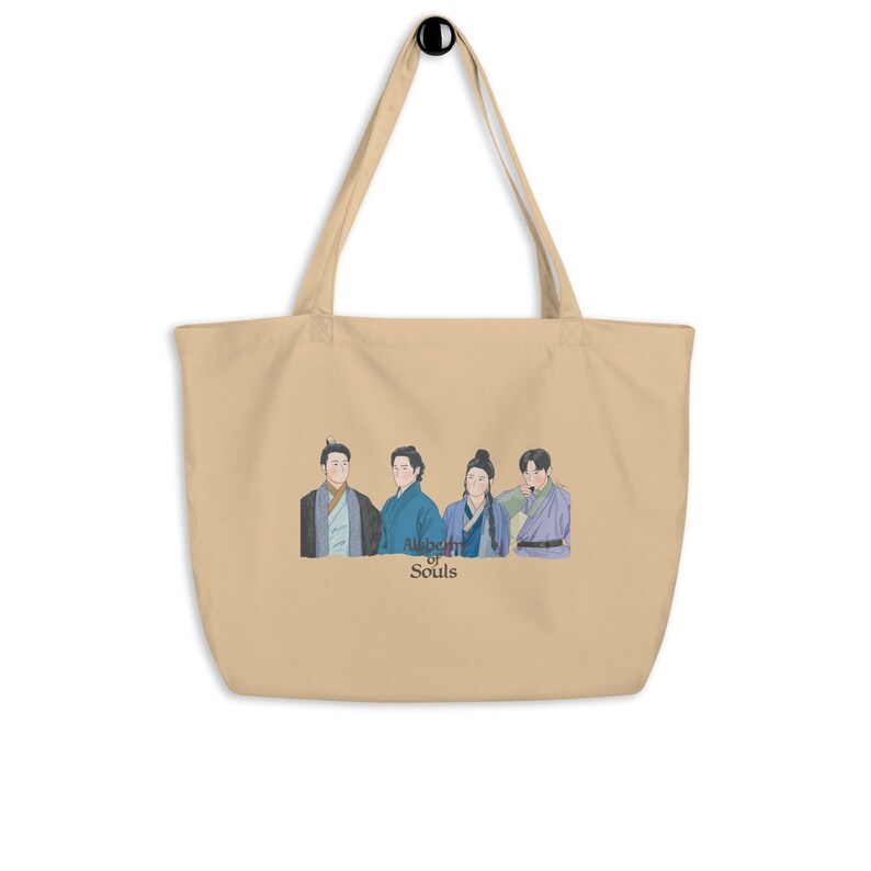 May include: A beige tote bag with a print of four people in traditional clothing. The text "Alchemy of Souls" is printed below the image.