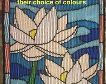 May include: A beaded wall hanging with a stained glass design featuring two pink water lilies with yellow centers, blue water, and a white and gray sky. The text "Completed by customer in their choice of colours" is visible in the image.