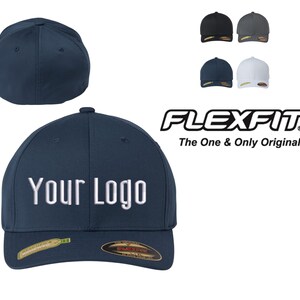 May include: A navy blue baseball cap with a white embroidered logo that says "Your Logo". The cap has a Flexfit logo on the back and is a one-size-fits-all design.