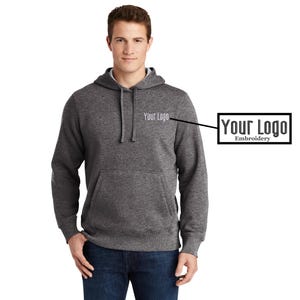 May include: A heather gray hooded sweatshirt with a front pocket and a white embroidered logo that says "Your Logo".