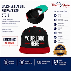 May include: A black and red flat bill snapback cap with the text YOUR LOGO HERE embroidered on the front. The cap features a six-panel structured design, an adjustable snapback closure, and a high profile. The underside of the bill is green.