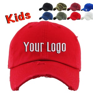 May include: Red distressed baseball cap with the text "YOUR LOGO" in white embroidery. The cap is for kids.
