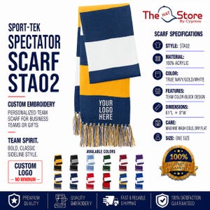 May include: A Sport-Tek Spectator Scarf STA02 featuring a color-block design in navy, gold, and white with fringe ends. The scarf displays the text YOUR LOGO HERE and measures 61 inches long by 8 inches wide. It is made of 100% acrylic material.