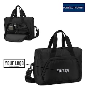 May include: Black nylon travel bag with a zippered closure, two top handles, and an adjustable shoulder strap. The bag has a large compartment with a zippered pocket and a smaller pocket on the front. The bag has the text "Your Logo" embroidered on the front.