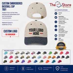 May include: A custom embroidered baseball cap in pigment-dyed cotton twill with a pre-curved bill and adjustable self-fabric strap with a brass buckle. The cap features the text YOUR LOGO HERE in black embroidery on a light tan crown with a dark brim.