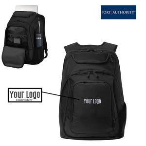 May include: A black Port Authority backpack featuring multiple zippered compartments, adjustable shoulder straps, and side pockets. The front panel displays the text Your Logo in white embroidery, with an open view showing internal storage.