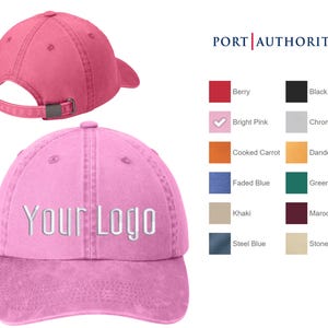 May include: A pink cotton baseball cap with a white embroidered "Your Logo" on the front. The cap has a curved brim and an adjustable strap in the back.