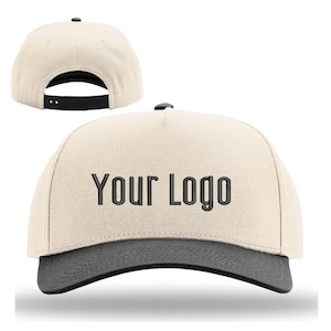May include: A beige baseball cap with a dark gray brim and the text "Your Logo" embroidered on the front. The cap has a black adjustable snapback closure and a black button on top.