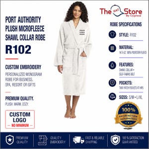 May include: A white Port Authority plush microfleece shawl collar robe, style R102, featuring a self-fabric belt and two patch pockets at the hips. The robe is made of 14.5-ounce 100% polyester fleece and includes space for custom embroidery.
