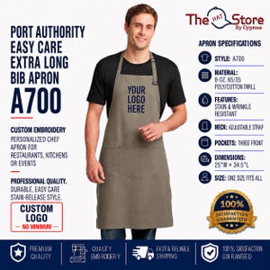 May include: A taupe Port Authority Easy Care extra long bib apron, style A700, featuring an adjustable neck strap and three front pockets. The apron is made of 8-ounce 65/35 poly/cotton twill, measures 25 inches wide by 34.5 inches long, and is stain and wrinkle resistant.