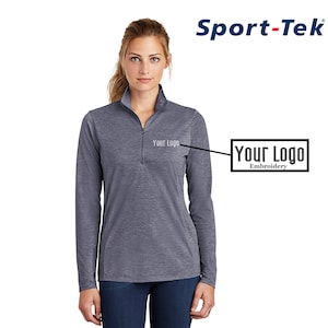 May include: A heather gray long-sleeve shirt with a zippered collar. The shirt has a small embroidered logo that says "Your Logo" on the left chest.