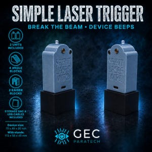 May include: Two grey, tombstone-shaped electronic laser trigger devices with the text SPIRIT LASER WIRE embossed on the front. Each unit sits on a black square base. The devices feature a small light at the top and a USB port at the bottom.