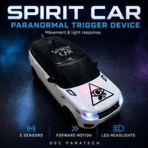 May include: A white and black toy SUV labelled SPIRIT CAR PARANORMAL TRIGGER DEVICE with movement and light response. The bonnet features an eye-in-triangle graphic, two sensors, and illuminated LED headlights. The roof is marked SPIRIT CAR.