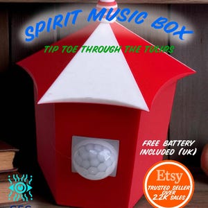 May include: A red and white Spirit Music Box with the text "SPIRIT MUSIC BOX" and "TIP TOE THROUGH THE TULIPS". The box has a motion sensor and a small Etsy badge. The text "FREE BATTERY INCLUDED (UK)" is also visible.
