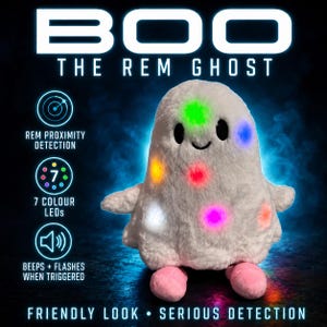 May include: A white plush ghost toy named BOO THE REM GHOST with black eyes and pink feet. The ghost features seven colored LED lights that glow. Text on the image includes REM PROXIMITY DETECTION, 7 COLOUR LEDS, BEEPS + FLASHES WHEN TRIGGERED.