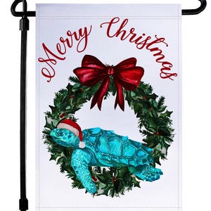May include: A white garden flag with a teal turtle wearing a Santa hat inside a green wreath with a red bow. The words "Merry Christmas" are written in red script across the top.