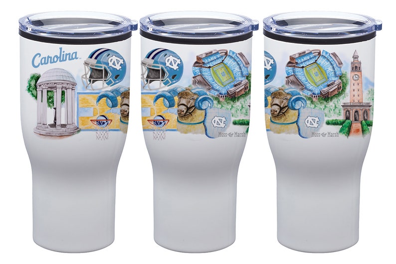 May include: White insulated tumbler featuring illustrations of the University of North Carolina. The design includes the word "Carolina", a football helmet, a stadium, a ram, and a bell tower. The tumbler has a black lid.