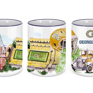 May include: Three white ceramic mugs with a blue rim. Each mug features a different image related to Georgia Tech: a building, a football stadium, and a vintage car. The mugs all have the Georgia Tech logo and the words "Georgia Tech" printed on them.