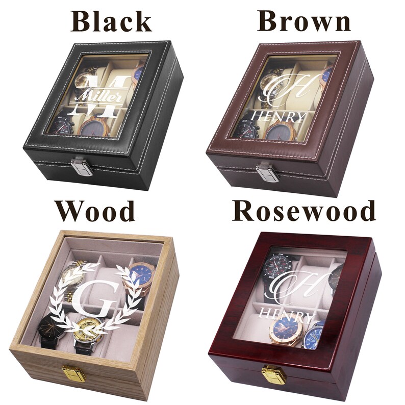 May include: Four watch display cases in black, brown, wood, and rosewood. Each case has a glass top, a silver clasp, and a light-colored interior. The black case has the name "Miller" and the letter "M". The brown case has the name "Henry" and the letter "H". The wood case has the letter "G" and a laurel wreath. The rosewood case has the name "Henry" and the letter "H".