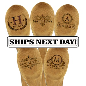 May include: Five light brown wooden spoons with laser-engraved text and decorative flourishes. The spoons feature the names HILARY, MATTHEWS, ANDERSON, MACKENZIE, and MEREDITH, along with initials and ornate borders. A white banner displays SHIPS NEXT DAY!