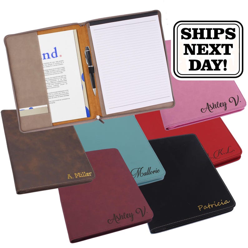 May include: A collection of rectangular faux leather portfolios in various colours including brown, teal, red, black, and pink. Each portfolio features a personalised name embossed on the front cover and an interior with a notepad and pen holder.