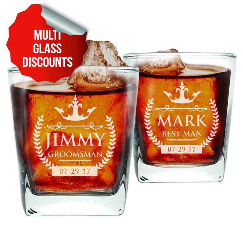 May include: Two clear glass whiskey tumblers with a white design. The tumbler on the left says "Jimmy Groomsman 07-29-17" and the tumbler on the right says "Mark Best Man 07-29-17".