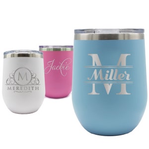 May include: Three insulated stemless wine tumblers in white, pink, and light blue. The white tumbler has a monogram with the name "Meredith". The pink tumbler has the name "Jackie". The light blue tumbler has the name "Miller". All tumblers have silver lids.