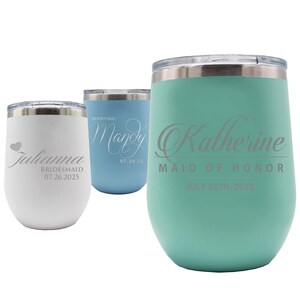 May include: Three insulated stemless wine tumblers in white, light blue, and teal. Each tumbler has a silver lid and features custom text, including names, titles, and dates. The white tumbler has a heart graphic.
