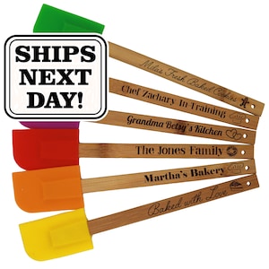 May include: A set of six silicone spatulas with wooden handles, each featuring a different colored head in green, purple, red, orange, and yellow. The handles are engraved with custom text and icons, including SHIPS NEXT DAY! in a white box.