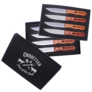 May include: A set of six steak knives with wooden handles in a black box. The handles are engraved with the name "Christian" and a cow silhouette. The box has the text "Christian King of the Grill" with a cow, grill, and flames graphic.