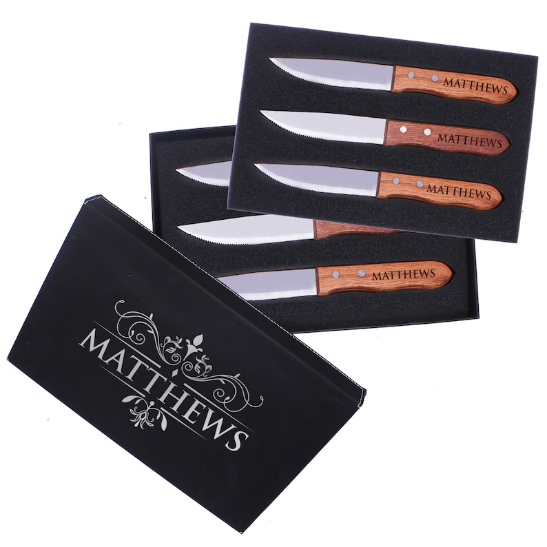 May include: A set of four steak knives with wooden handles in a black box. The knives are engraved with the name "MATTHEWS".