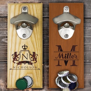 May include: Two wooden bottle openers with metal tops. One is light wood with a crest and the name "Nicholson". The other is dark wood with the name "Miller". Both have bottle caps below.
