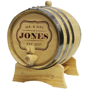 May include: A small wooden barrel with metal hoops and a wooden spigot. The barrel is engraved with "MR. & MRS. JONES EST. 2021".