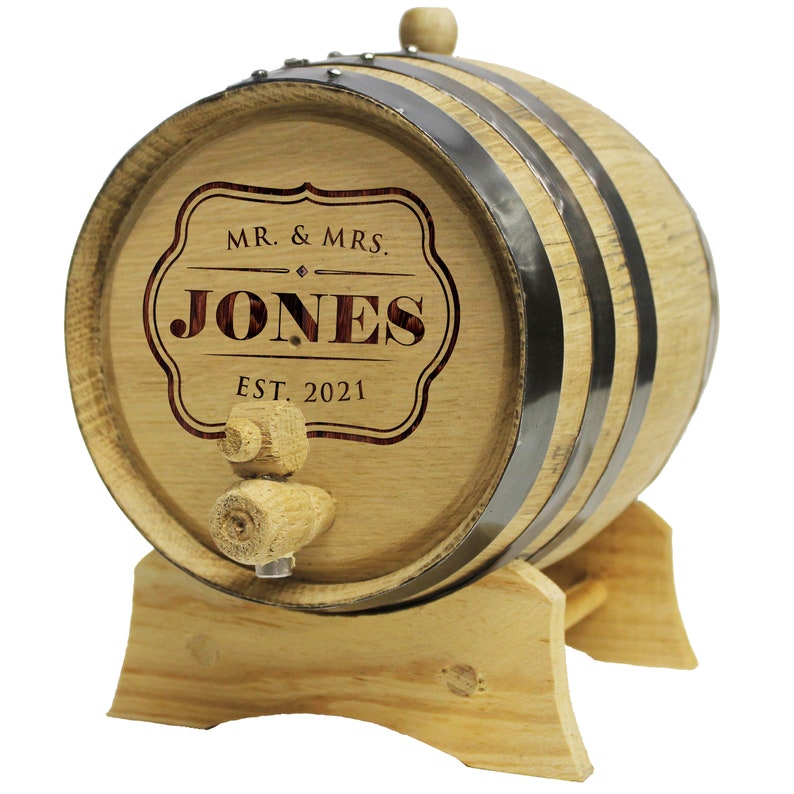 May include: A small wooden barrel with metal hoops and a wooden spigot. The barrel is engraved with "MR. & MRS. JONES EST. 2021".