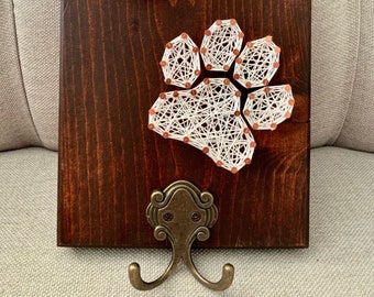Soporte para correa de perro con diseño de huellas de patas y colgador de llaves para mascotas.