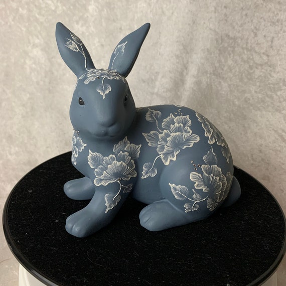 Blue Bunny decoated with roses that are hand painted with a texture medium that gives them dimension.  It is also accented with crystals.