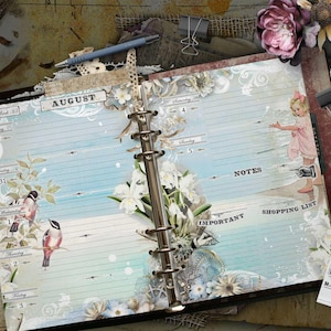 An open ring-bound planner with light blue lined pages featuring the text AUGUST, Week 33, Monday, Tuesday, Wednesday, Thursday, Friday, Saturday, Sunday, NOTES, IMPORTANT, and SHOPPING LIST. The pages are decorated with illustrations of birds, white flowers, and a small child in a pink dress.