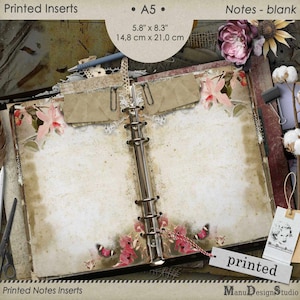May include: An A5 size blank notebook with a floral design on the cover. The notebook is open to reveal blank pages. The notebook measures 5.8 inches by 8.3 inches or 14.8 centimetres by 21.0 centimetres.