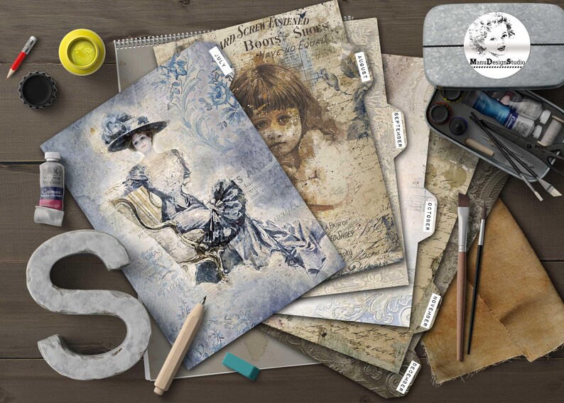 May include: A collection of vintage-style paper ephemera, including pages with illustrations and text, arranged on a wooden surface. Art supplies like paint, brushes, and a pencil are also present, along with a metal container with a logo.