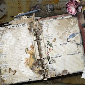 An open ring-bound planner with cream-colored lined pages featuring vintage-style illustrations of a person, a butterfly, a bird, and botanical elements. The text includes October, Notes, Important, and Shopping List. Accessories include a feather, scissors, a pen, and cotton stems.