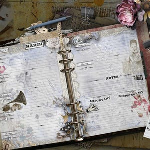 May include: An open ring-bound planner with lined pages featuring the month of March, week 11, and dates 15 through 21. The pages include vintage-style illustrations of a gramophone, a hand, and text labels for Notes, Important, and Shopping List.