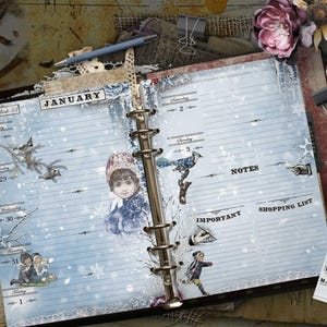 May include: An open ring-bound planner with light blue pages featuring a winter theme. The pages display the month of January, lined sections for days of the week, and headers for notes, important tasks, and a shopping list with vintage illustrations.