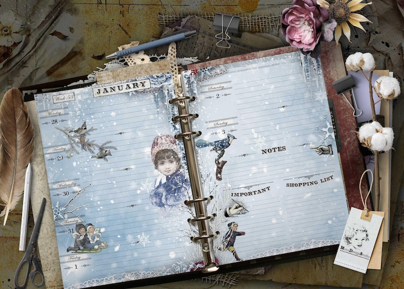 May include: An open ring-bound planner with light blue pages featuring a winter theme. The pages display the month of January, lined sections for days of the week, and headers for notes, important tasks, and a shopping list with vintage illustrations.